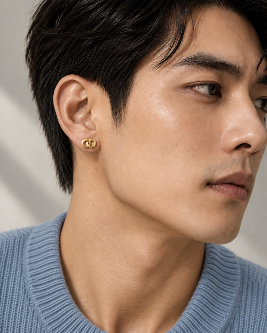 Man wearing the AEQUORO Single Stud earring in 18k yellow gold